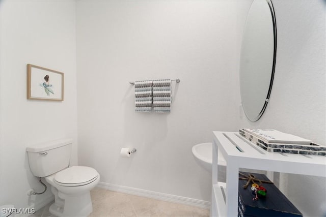 bathroom with toilet and tile patterned floors