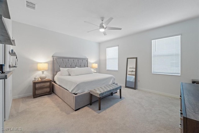 bedroom with ceiling fan and light carpet