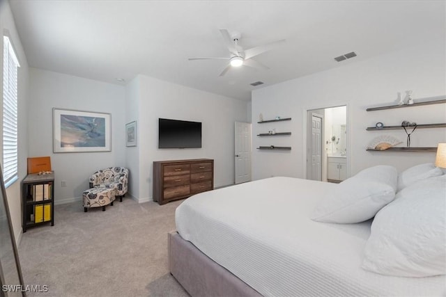 carpeted bedroom featuring ensuite bath and ceiling fan