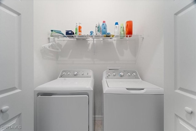 laundry room with washing machine and clothes dryer