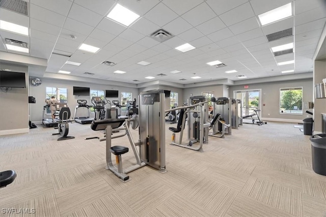 exercise room with light carpet and a drop ceiling