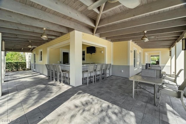 view of patio / terrace featuring ceiling fan and an outdoor bar