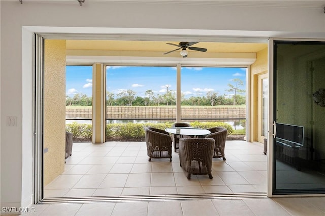 18530 Sandalwood Pointe Unit 101, Fort Myers, FL 33908 - sunroom featuring a water view, a ceiling fan, and tile patterned floors