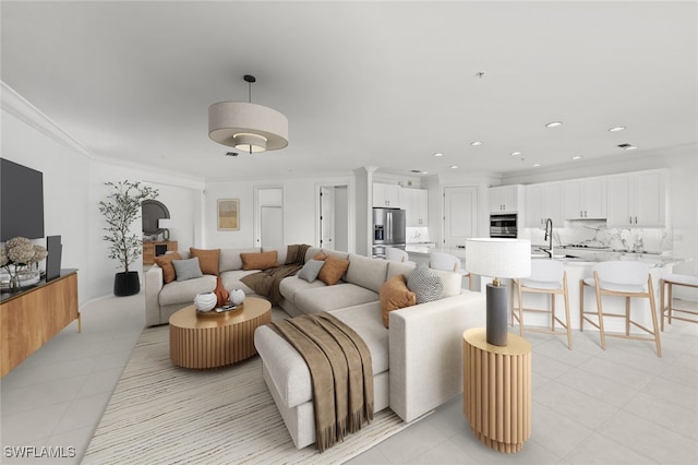 living room with light tile patterned floors, ornamental molding, and sink