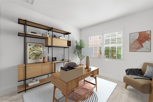 office space featuring visible vents, baseboards, and wood finished floors