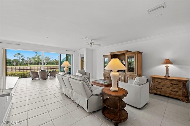 tiled living room with ceiling fan and ornamental molding