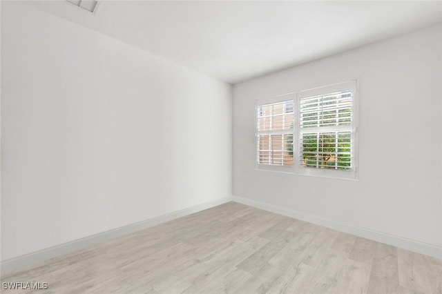 empty room with light hardwood / wood-style floors