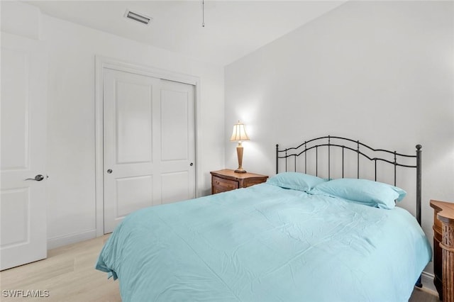 bedroom featuring a closet and light wood-type flooring