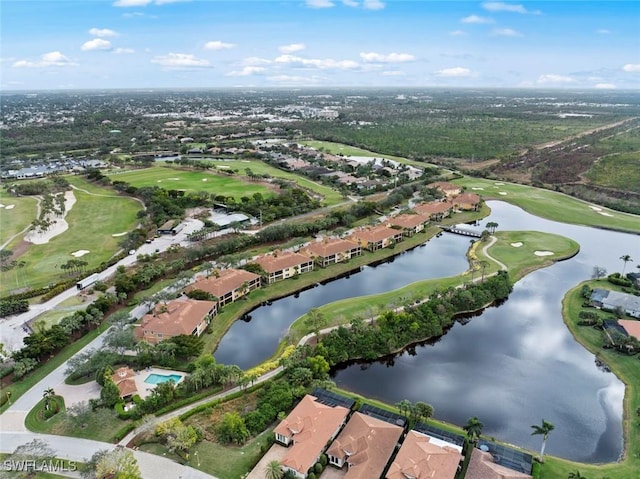 drone / aerial view with a water view and golf course view