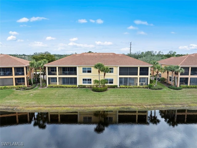 rear view of property featuring a yard and a water view