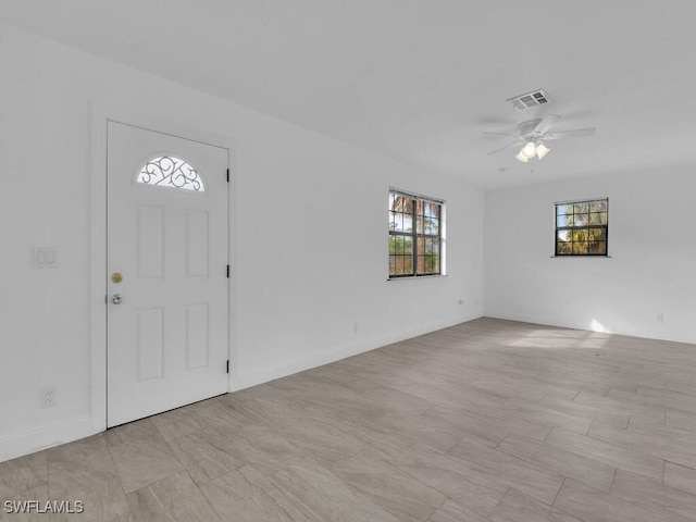 entrance foyer with a wealth of natural light and ceiling fan