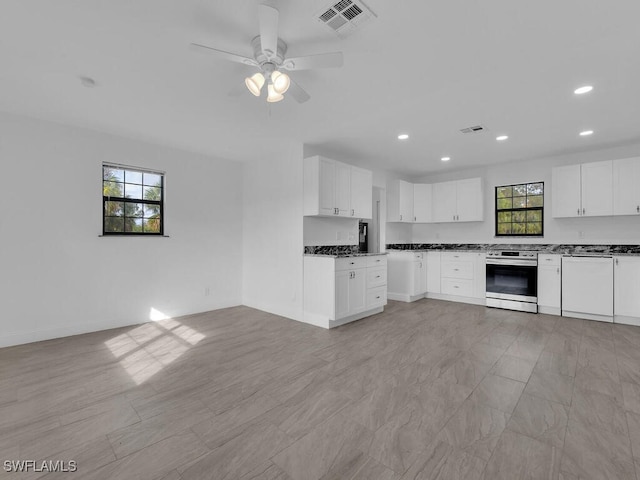 kitchen featuring white dishwasher, stainless steel stove, white cabinetry, and ceiling fan