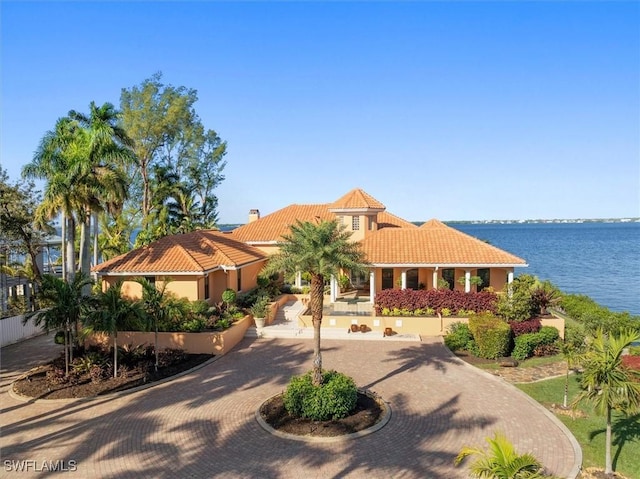 mediterranean / spanish house with a water view