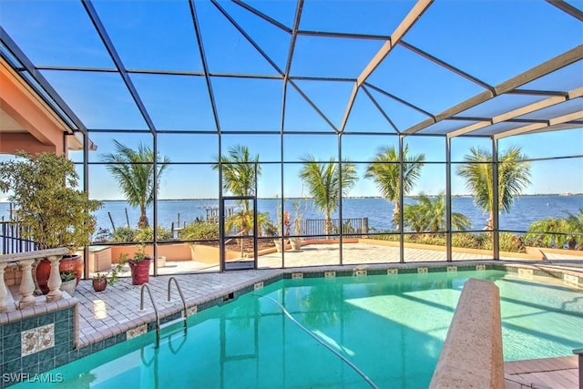 view of swimming pool with a lanai, a patio area, and a water view