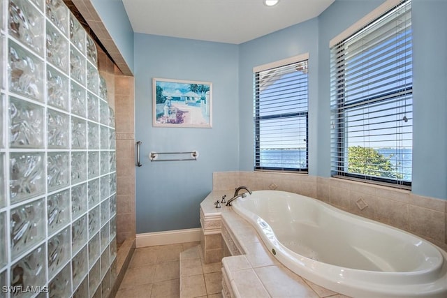 bathroom featuring tile patterned floors and separate shower and tub