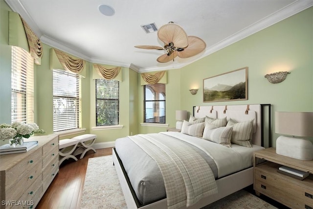 bedroom with ceiling fan, crown molding, and dark hardwood / wood-style floors