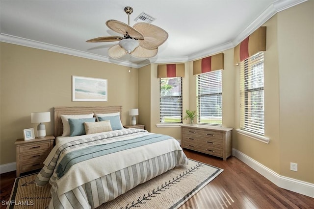 bedroom with ceiling fan, dark wood-type flooring, and ornamental molding