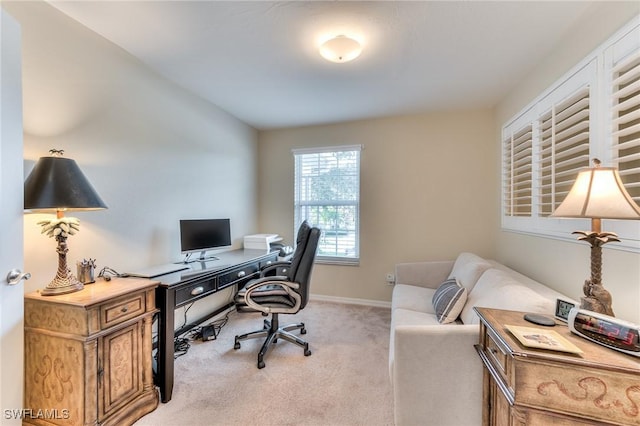 office area featuring light carpet