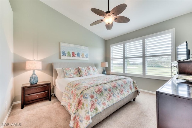 bedroom featuring ceiling fan, vaulted ceiling, light carpet, and multiple windows