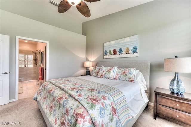 carpeted bedroom featuring ceiling fan and ensuite bath