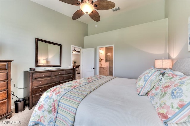 carpeted bedroom featuring ceiling fan and ensuite bathroom