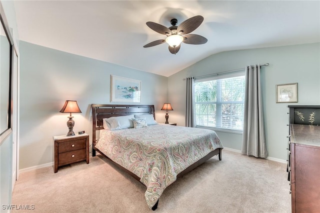 bedroom featuring lofted ceiling, light carpet, a closet, and ceiling fan