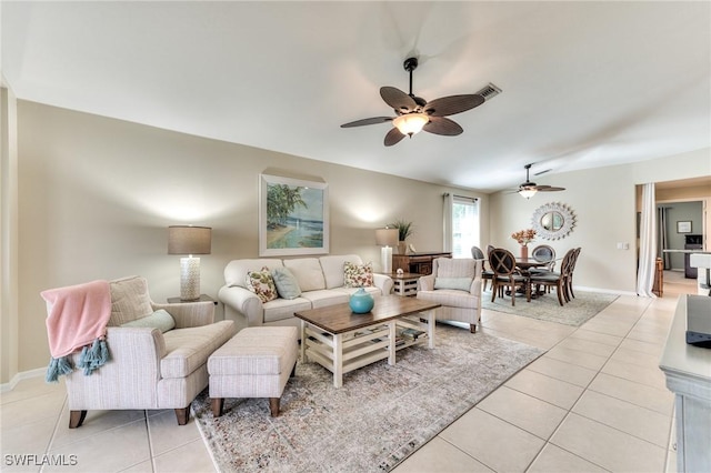 living room with ceiling fan and light tile patterned flooring