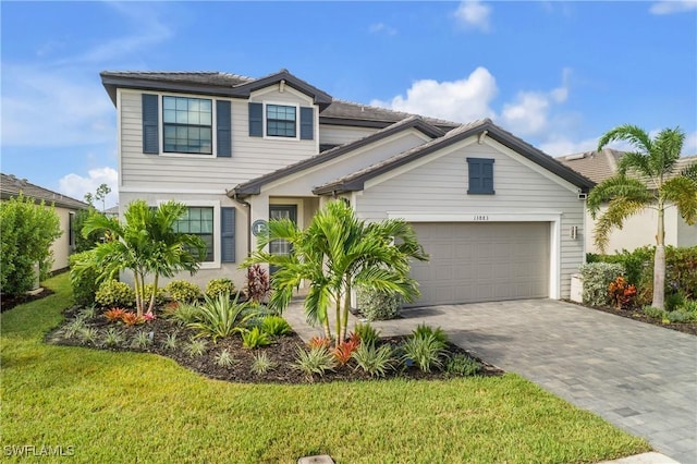 view of front of home featuring a garage and a front yard