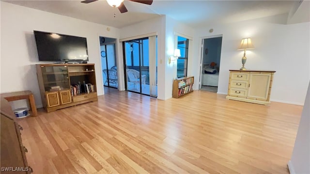 living room featuring ceiling fan and light wood-type flooring