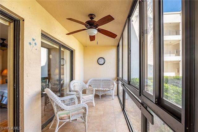 sunroom with ceiling fan and vaulted ceiling