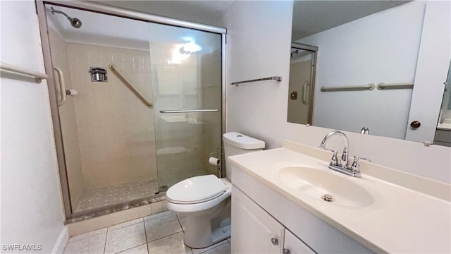 bathroom featuring tile patterned floors, vanity, toilet, and walk in shower