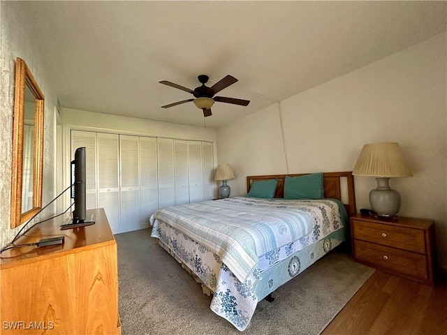 bedroom featuring hardwood / wood-style flooring, ceiling fan, and a closet