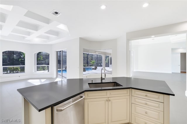 kitchen with coffered ceiling, sink, dishwasher, beamed ceiling, and cream cabinetry