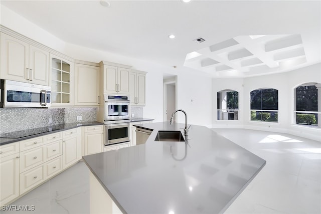 kitchen featuring beamed ceiling, tasteful backsplash, sink, coffered ceiling, and stainless steel appliances