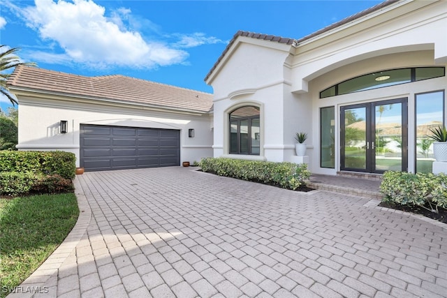 view of front of house with french doors and a garage