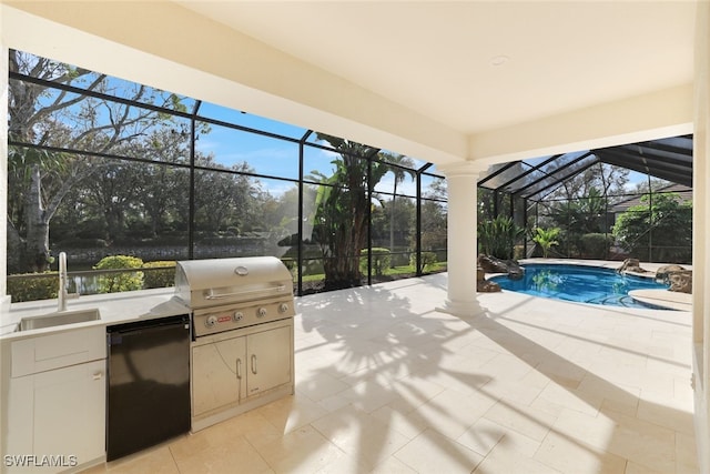 view of patio / terrace with grilling area, exterior kitchen, and a wet bar