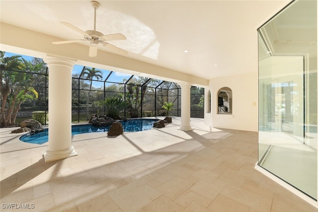 view of pool with ceiling fan, a patio area, and glass enclosure