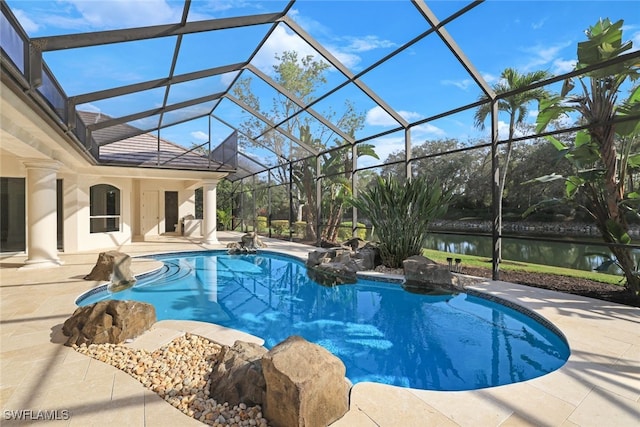 view of pool featuring a patio, a water view, and glass enclosure