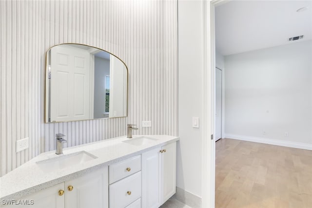 bathroom featuring vanity and hardwood / wood-style floors