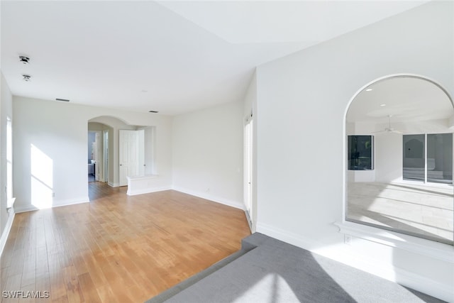 empty room with hardwood / wood-style flooring and ceiling fan