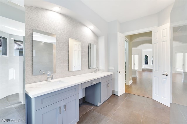 bathroom with vanity, backsplash, and tile patterned flooring