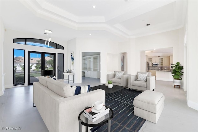 living room featuring a high ceiling and french doors