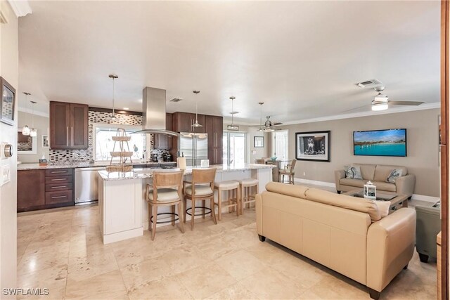 living room with plenty of natural light, ornamental molding, and ceiling fan