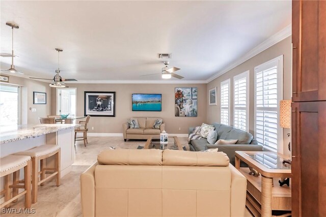 living room featuring ceiling fan and ornamental molding