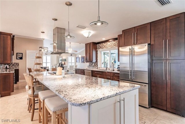 kitchen featuring stainless steel appliances, a center island, and hanging light fixtures