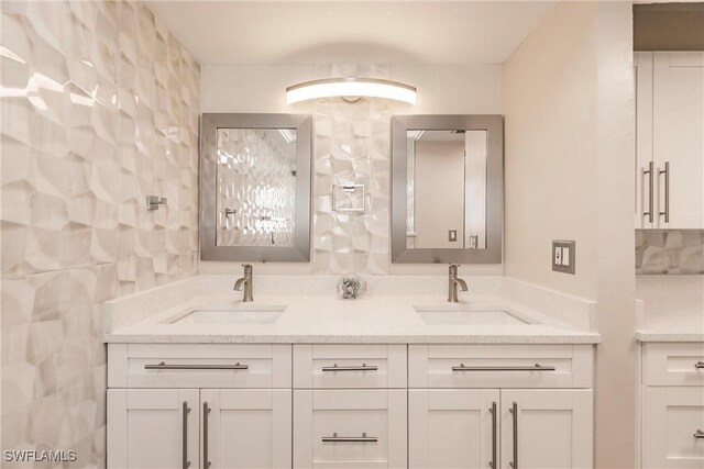 bathroom with vanity and tile walls