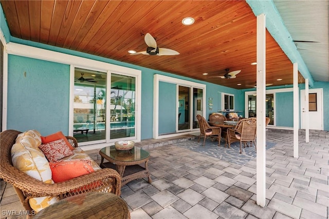 view of patio / terrace with an outdoor living space, outdoor dining area, and a ceiling fan