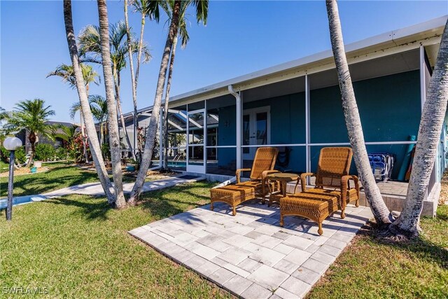 view of patio featuring a lanai