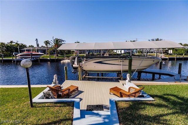 view of dock featuring a water view, a yard, and boat lift