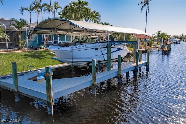 view of dock featuring a yard, a water view, and boat lift